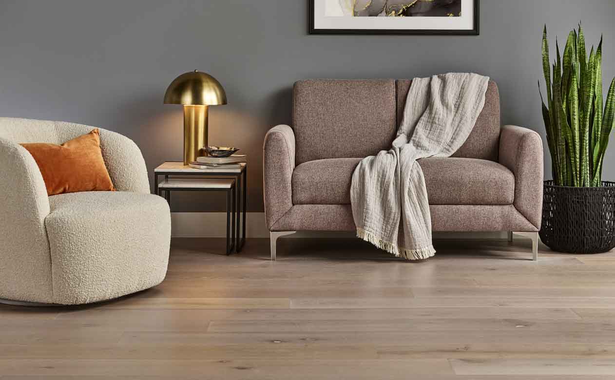 Hardwood flooring in a living room with a loveseat and accent chair